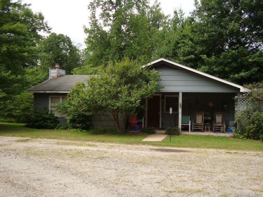 Investment Opportunity! This 3.5 ac parcel has a 2 BR, 1.5 BA fixer-upper spacious kitchen, LR w/ FP & office. Behind the house is a lower section with a separate well & septic, (previously accommodated 3 mobile home rentals). Convenient location between Columbus & Tryon. Features a 30x50 barn, (1500 sf) w/ 2 Lg doors for ease of getting large vehicles in and out. It was previously used for automobile repair & body work/painting, currently used for storage. Abundant parking & somewhat private.