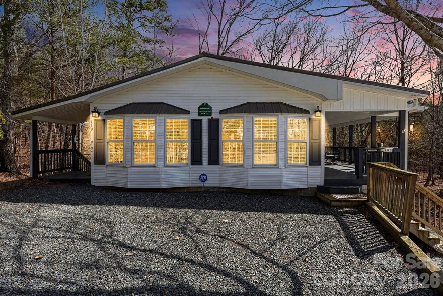 Imagine having your morning coffee on this fantastic covered porch every single day! This beautiful modular home features 2 bedrooms and 2 full baths with an inviting open-concept living, dining, and kitchen area designed for easy living and entertaining. The remodeled kitchen showcases updated cabinetry, a large island perfect for gathering with family and friends, stunning wood countertops, stainless steel appliances, updated lighting, new flooring, and more. The unfinished basement offers endless possibilities — create a recreation space, workshop, hobby area, or utilize it for additional storage. (Basement is not accessible from inside the home.) Whether you’re searching for a full-time living or part-time Lake Life retreat, this property checks all the boxes. Residents enjoy incredible amenities including lake access, swimming pool, marina, beach area, playgrounds, on-site restaurant, putt-putt golf, basketball courts, and more. Come experience lake living at its best!