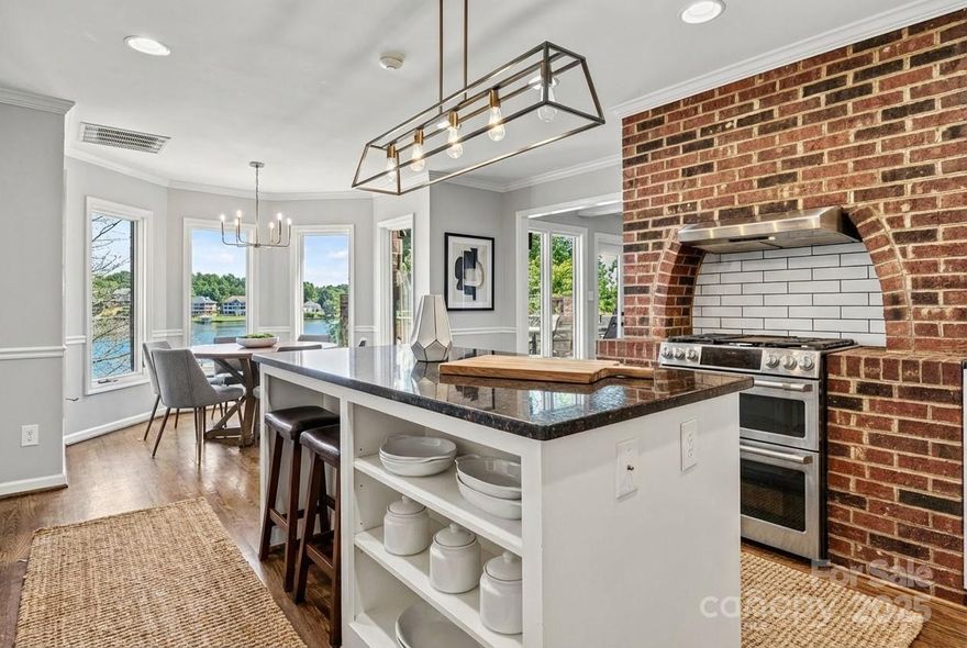 Enjoy million-dollar views from this grand lakefront home in one of Hickory’s most prestigious neighborhoods. Nestled into a private, 0.46 acre lot, this 5 BR home offers year round views of Lake Hickory offering over 141' of water frontage and dual covered boat dock.

The soaring 2 story foyer opening welcomes you into a formal living room and bay window dining room, a spacious great room with beamed ceilings, a gas-log fireplace, wet bar, and unobstructed main-channel lake views and updated kitchen.  The conveniently located eat-in kitchen includes an expansive center island, custom cabinetry, granite countertops  and a bayed breakfast area. You will also find a generously sized laundry room, half bath and a private guest bedroom with full bath on the main level.

Upstairs, the luxurious primary suite includes a fireplace, a private bay windowed sitting area overlooking the lake, and a spa-inspired bath with double vanity, heated tile flooring, walk-in tiled shower, and a huge walk-in closet. Secondary bedrooms are bright and spacious—two of which offer private balconies with serene views.

The full unfinished basement is already plumbed, providing excellent potential for future expansion, and includes a walk-in cedar closet perfect for off-season storage. Enjoy outdoor living on the recently updated back deck overlooking the backyard and private boat dock.

Located in a wonderful community with a pool and low HOA dues, this exceptional lakefront property truly has it all!