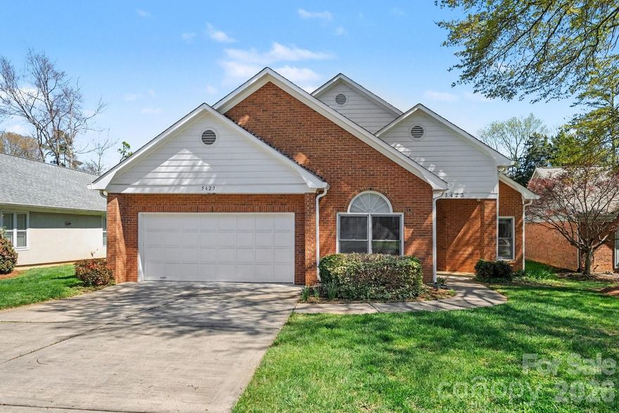 Low-maintenance living in the desirable Dunedin neighborhood! This charming 4-bedroom, 2-bath ranch home features an open floor plan with beautiful wood flooring and high ceilings throughout the main living areas. The spacious layout is complimented with a 2-car garage and a large heated and cooled sunroom with a ton of natural light—perfect for relaxing year-round while enjoying views of the private backyard, bordered by mature bushes for added privacy. The living room features built in shelving on both sides of the cozy gas fire place. The primary suite welcomes morning sunlight and includes a dual vanity, large jet tub and shower that lead to your walk-in closet.  Ideally located between Strawberry Hill and Arboretum shopping centers and less than 10 minutes from SouthPark, this home offers both convenience and tranquility. The quiet community features private walking trails and the HOA handles yard and lawn maintenance for truly easy living without the worry of cut-through traffic. 2016 architectural shingle roof and gutters, 2023 water heater and 2011 HVAC.