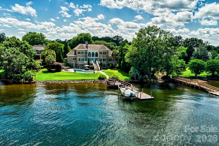 Back on Market to NO FAULT OF THE SELLER! Perched on the most coveted lot in the prestigious gated community of Spence Plantation, this one-of-a-kind waterfront estate offers a lifestyle of unrivaled privacy, exclusivity, and luxury. Constructed entirely of premium natural stone and spanning over 6,700 sq ft across 3.5 meticulously designed levels, this architectural masterpiece commands attention with panoramic, unobstructed lake views from every room and over a MILLION DOLLARS in upgrades. Your private resort awaits; Every day feels like an opulent vacation—set on 215 ft of prime shoreline with breathtaking, oceanesque views. Float in the saltwater pool, unwind in the hot tub spa or sauna, or walk out on your updated dock with convenient boat lift, all from the comfort of your own backyard. Tucked at the end of a quiet cul-de-sac, the home is surrounded by lush, mature, professional landscaped grounds that offers unmatched seclusion. A custom brick-laid driveway flanked by majestic live oaks leads to an estate that feels worlds away-yet is just minutes from everything! Inside, 20' soaring ceilings, 12” crown molding, & wall-to-wall water views elevate the elegance. The recently updated gourmet chef’s kitchen features a built-in SubZero fridge, Dacor gas cooktop & double ovens, extensive cabinetry, & a massive walk-in pantry. There is no shortage of cabinetry or countertop space. The luxurious primary suite is a private sanctuary with stunning lake views, French doors opening to the terrace, custom mechanical blackout shades, and a completely remodeled primary en suite featuring dual walk-in closets, dual vanities, custom spa shower, and an oversized jetted soaking tub. Designed for both relaxed living & grand entertaining, the home includes a theater, fitness room, two additional kitchenettes (one on every level), and spacious secondary bedrooms. Every detail has been thoughtfully curated—from renovated baths to abundant storage. This is more than a home- it’s a statement. A sanctuary. A once-in-a-lifetime opportunity to own the most iconic property in the neighborhood, and perhaps on the lake. Come home to the pinnacle of lakefront living. You’ll never want, or need to, leave. Agent related to seller