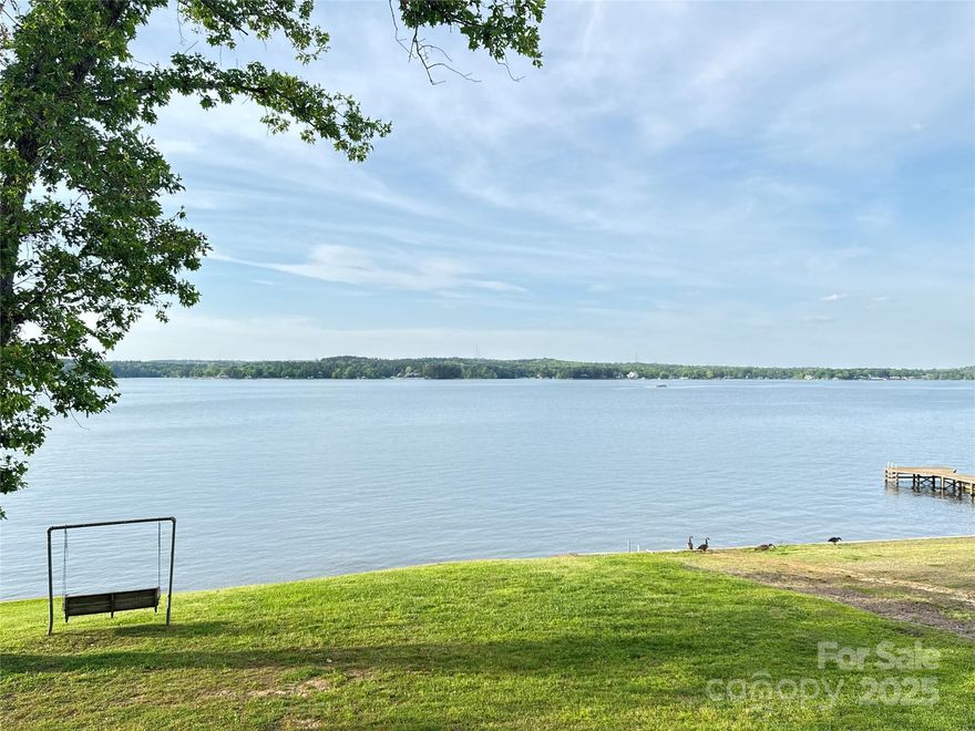 Amazing main channel views from this slightly elevated property. Almost an acre with expansive keystone retaining wall, sandy beach, enclosed outdoor shower, VERY rare boat ramp with boat house on the waters edge with wench. The home has been updated by a GC with a gorgeous kitchen with custom cabinetry, granite counters and stainless appliances. The split floorplan has 2 bedrooms and 1 bath on one side and a primary with en suite and 4th bedroom or designated office on the other side. The master bath has been upgraded also with custom cabinetry, granite vanity with double sink, stone trim around the garden tub and white subway tile around the shower. The master bed has his and hers closets. All centered around the great room, kitchen and dining room with views out to the porch that spans the entire front of the house. The roof was replaced in 2023. The entire yard has been sodded and there is a lake fed irrigation system. The dock was built new in 2023. This property is a must see!