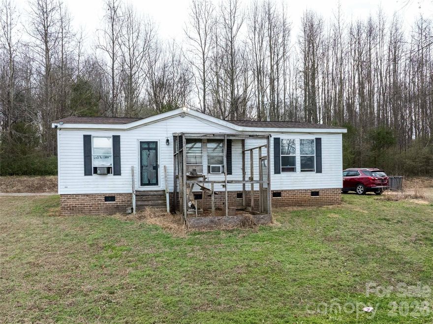 Enjoy peaceful country living on over 2 acres at 1377 Nance Road in Peachland, NC. This property features a small bubbling brook, open farmland, and a quiet rural setting just 30 minutes from Wadesboro and Monroe. The 2005 manufactured home offers 3 bedrooms, 2 full baths, and approximately 1,080 sq ft, with a new roof. Interior includes original kitchen with laminate countertops, stainless steel appliances (stove, microwave, dishwasher, washer and driver), plus a stand-up freezer and extra cabinetry.