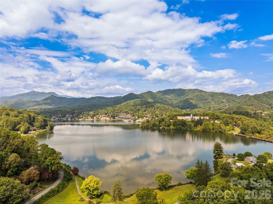 Welcome to 21 Gunter Drive, a 3-bedroom, 3-bathroom home perfectly situated on a corner lot with picturesque views of Lake Junaluska from the comfort of your living room. The 3rd bedroom can be the ideal in-law suite or entertainment/bonus room. This inviting property blends privacy and convenience, surrounded by mature landscaping while being just minutes from both the lake and downtown Waynesville.

Inside, you’ll find a bright and functional layout that makes the most of its space. The living room is the highlight, offering a front-row seat to lake and mountain views. The kitchen and dining areas provide plenty of room for gathering, while the three bedrooms and three full baths ensure comfort and flexibility for family or guests.

The exterior is just as appealing, featuring classic mountain character, a paved drive with covered parking, and a handicap accessible ramp for added convenience. Outdoor living is well-designed with a back patio, a screened-in porch, and an open-air porch—perfect for relaxing, entertaining, or soaking in the mountain surroundings.

Enjoy easy access to Lake Junaluska’s walking trails, recreation, and events, along with Waynesville’s vibrant shops, dining, and cultural experiences just a short drive away.

Whether you’re searching for a full-time residence or a long-term rental, this home offers the best of Western North Carolina living.