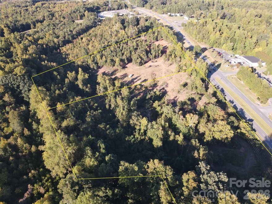20.35+/- acres (gross) of commercial land located on the southbound side of Hwy 321 (York Hwy) at the state line with 16.47+/- net acres.  8.47+/- net acres are in Gaston County, NC (parcel# 147878) and 8+/- net acres are in York Co, SC (tax parcel# 3730000006). This is one tract of land but because it is in both counties, each county collects their respective taxes. The Gaston Co, NC side is zoned C-2 Highway Commercial and within the "opportunity zone". The York Co, SC side is zoned UD (Urban Development). See document section for more details on zoning. The the timber on the property around 2014, much of the brush cleared away in recent years. A significant amount of the land is at or close to road level. Water is available on both the NC and SC side. Sewer is available on NC side but will require a lift station or pressurized system (see document section for sewer map). Tax value that is shown is the combination of both counties. Phase 1 environmental study and Preliminary Wetlands reports are available upon request.