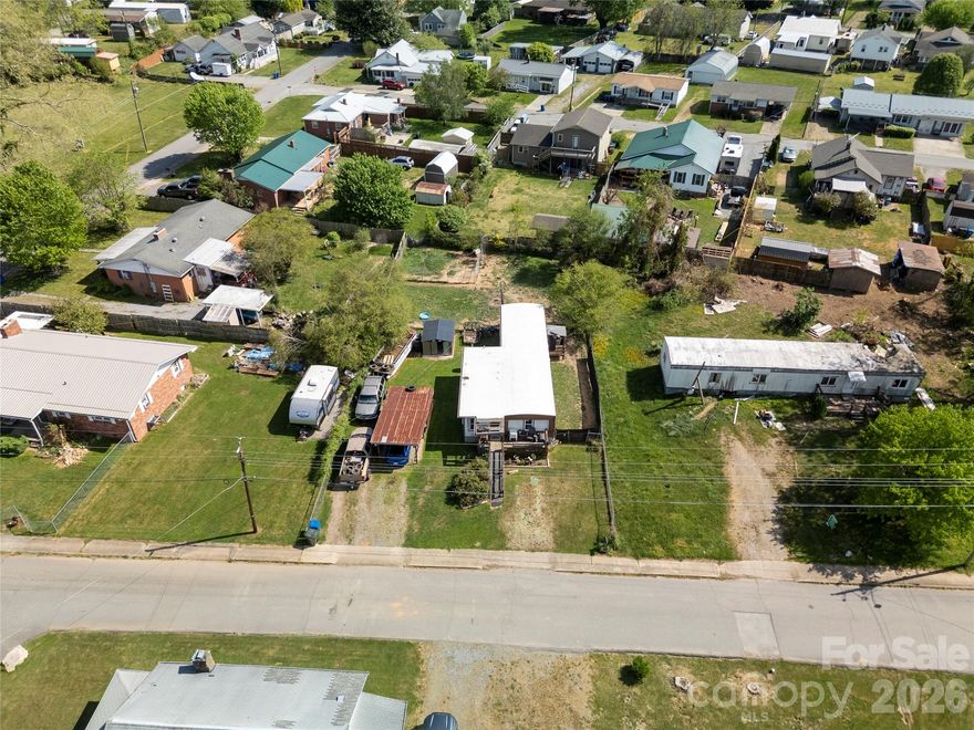 Looking for a 3-bed mobile home in Waynesville close to town with utilities already in place? This 3-bedroom, 2-bath single-wide at 114 Brook Street offers a practical layout on 0.23 acre with public water and sewer, covered parking, and added storage, making it a solid option for investors or buyers seeking value and potential. Built in 1981, the home features a functional floor plan with three bedrooms and two full baths, along with a front deck and ramp access for easy entry. Outside, the property includes a carport for covered parking and a detached outbuilding that works well for storage, tools, or a small workshop. The yard offers usable space with some fencing already in place, providing flexibility for pets, gardening, or future improvements. Located just minutes from downtown Waynesville, the home offers convenient access to local shops, restaurants, and daily essentials while still being tucked into a residential neighborhood with mountain surroundings visible nearby. The property has been used as a long time rental, presenting an opportunity for continued income, renovation, or repositioning based on your goals. This property is being sold as is. If you are searching for a 3-bed mobile home in Waynesville with strong potential and a convenient in town location, this property is worth a closer look.