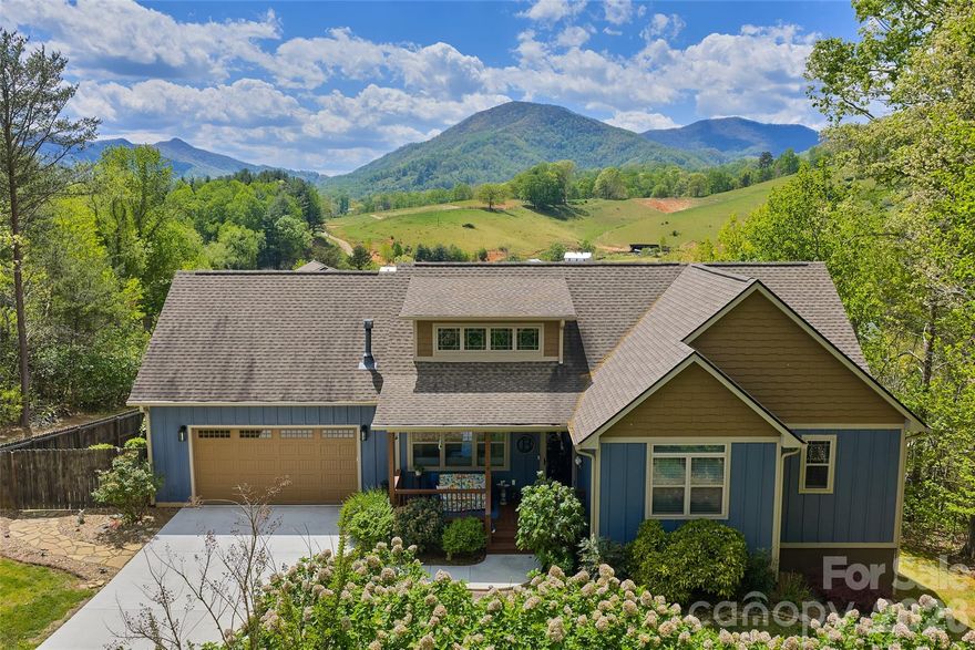 If views are what you're after this is the one: the epitome of bucolic Western NC living in a quality 2016 Arts and Crafts home. Nestled on a gently sloping 1.09-acre lot in the lovely Oak Grove Plantation, this 3-bedroom, 3.5-bath residence offers breathtaking, year-round mountain views and the ease of main level living. 

The open-concept features vaulted ceilings, great room with gas fireplace, grill with direct propane line connection, a gourmet kitchen with a central island and pantry - perfect for entertaining, hardwood floors, two car main level garage and the bonus of two primary suites on the main with large walk in closets. If the weather is perfect have a drink outside in the screened porch or bask in the sun overlooking the gorgeous backyard views. 

The finished basement hardly feels like a basement with high ceilings, big windows and an abundance of living space, complete with a family room, bedroom, bathroom, workshop, and utility room. Outside is perfect for all lifestyles with professionally landscaped and hardscape grounds, a stone patio, a big beautiful hot tub and a custom fire pit - perfect for entertaining under the stars. Only 20 minutes from the heart of Asheville!
