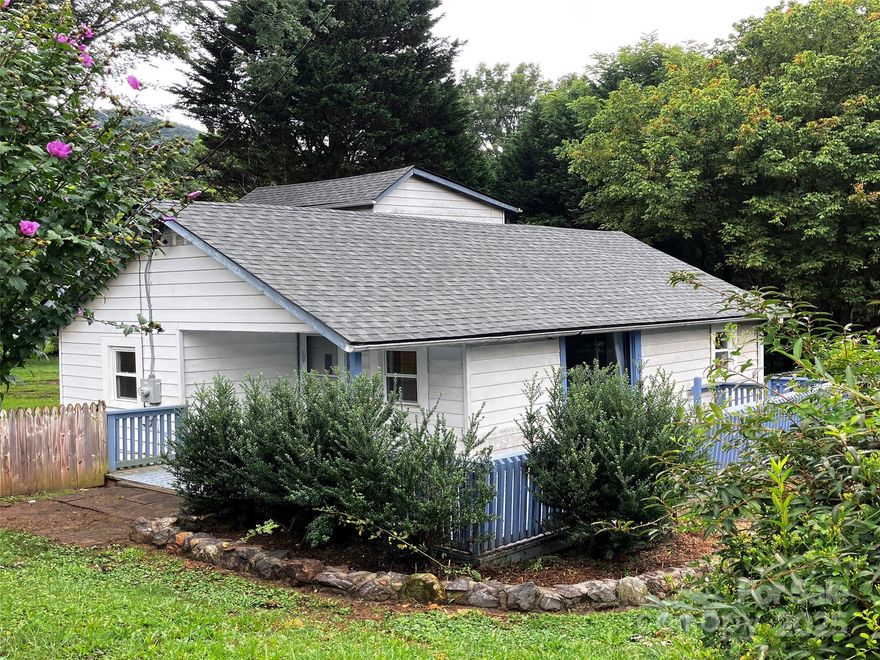 This charming farmhouse in Swannanoa is ready for your finishing touches.  Offering 3 bedrooms and 2 baths, the home is situated on a private corner lot with beautiful mountain views. The property experienced no impact from Hurricane Helene, and the seller has made thoughtful improvements to ensure it's move-in ready while allowing  the next owner to personalize and enhance over time.  Recent updates include a new roof (2023), new carpet in the living room and den (August 2025), and fresh paint throughout most of the main level rooms.  The fully fenced backyard features a fire pit and a newer storage building pre-wired for electricity , offering excellent flexibility for hobbies, storage, or workshop use.  Enjoy multiple outdoor living spaces with generous decking and covered areas at both the front and rear entrances-ideal for entreating or relaxing.  Conveniently located between Asheville and Black Mountain, the home provides easy access to dining, shopping, and outdoor recreation.