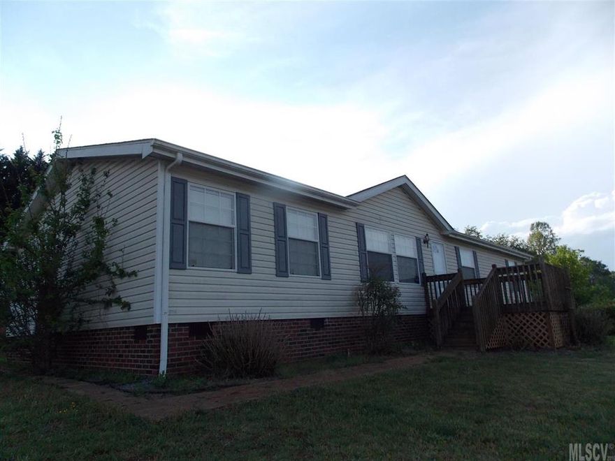 3BR/2BA manufactured home in excellent condition. Large open living & dining room. Kitchen with breakfast bar island and sliding glass door that leads onto deck. Master bedroom with large garden bath tub and walk-in shower. Electric fireplace insert and custom book case in living room.  Two outbuildings stay. Kinetic filter water system.