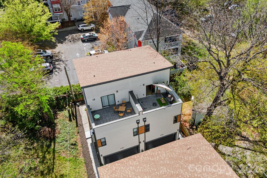 Currently Operating as a Short-Term Rental. Exciting Opportunity to Live, Work and Invest in Uptown Charlotte with a special "perk" for Buyer - 2026 Season Tickets for the Carolina Panthers with great end zone seats! This 3 story modern home is critically located between Uptown Charlotte Panthers and Knights stadiums and Frazier Park within it's two+ mile greenway. Capture the vibrancy of Uptown. Zoning allows for work/play living for your office and personal life and/or short term rentals for maximizing revenue and investments. All three floors are built for fun and comfort with open floor plans. The main floor has a two car garage and a studio with built in kitchen area, combination living/dining/sleeping area, full bath and walk-in closet. Studio may be accessed from it's own private entry or from the interior of the home. Upper floor flows beautifully with living/dining/kitchen with half-bath and laundry and the Penthouse floor provides a sanctuary for dreaming, creating and enjoying city life from it's rooftop terrace. Furnishings available by separate purchase. Parking Information is in photos. Current furnishing sleeps 5, but AirBnB tailored furnishings could sleep up to 12 without roll-a-way or inflatable beds. Water is separately metered and paid to HOA account holder. Listing agent is related to seller.