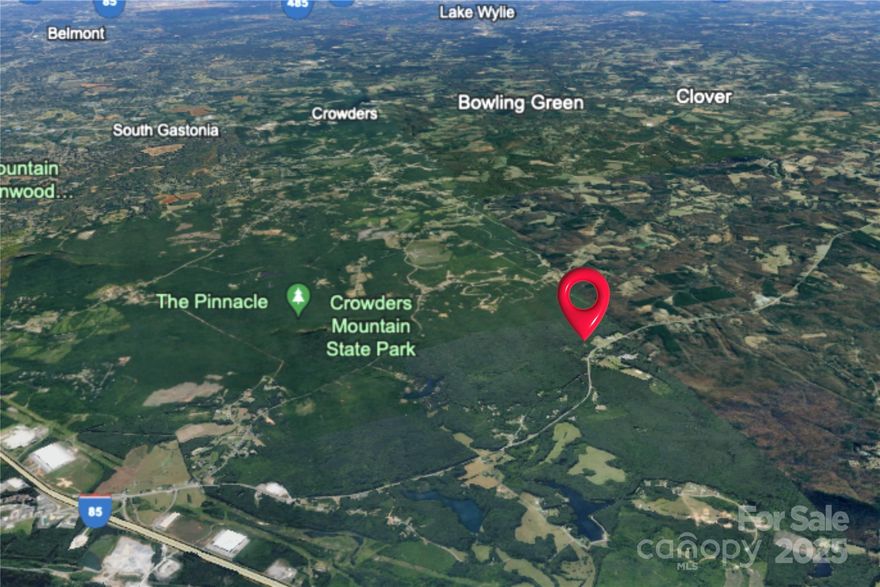 Nestled in a serene setting, this expansive 17.88 acre property offers a unique opportunity for those seeking tranquility without compromising convenience. Just minutes to Interstate 85, Crowders Mountain State Park, Kings Mountain National Military Park, the new Two Kings Casino, and Crowders Mountain Golf Course. With its generous size this lot is perfect for homeowners looking to build a secluded estate or cabin in the woods! Original quaint 1940's home site sits approx. 320 feet from York Rd/US 161. The land is rich with grapevines, apple trees, blackberry bushes, black walnut trees, pear trees and persimmon trees. Don't miss out on this exceptional opportunity to own a piece of paradise in a prime location.