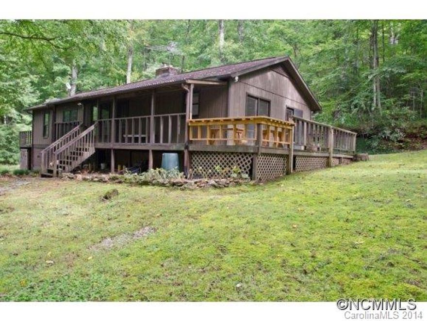 Privacy lovers DREAM! Property adjoins Pisgah National Forest/National Wildife Game Lands on 2 sides PLUS offers 2 on-site streams. Gently rolling site is mostly wooded with circular drive, extensive rockwork, fire pit area, and more! Great home for year round living or seasonal retreat. One level home with many updates. Open concept living, split bedroom design, 2 woodstoves, large master with sitting room(no closet). 25 min. drive to Asheville