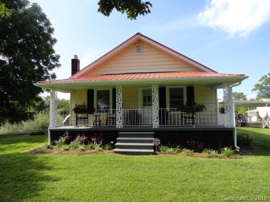 This charming 2 bedroom 1 bath farmhouse is situated on 12 fenced in acres. Home has just been freshly updated with all new paint throughout, new kitchen cabinets and appliances, all new flooring, gutters, and metal roof.  House flows well with great layout. Eat in kitchen with small bar opens up to the living room. Two good sized bedrooms, bath, laundry - mud room, and full unfinished basement. The 12 acres is completely fenced in with several separate fenced in pasture acres, barn, and small flowing stream. Also on the property is an additional home-site with separate septic, and a 24 x 12 storage building. Storage building has solar panels that operate a supplemental furnace for the home. Lovely in-ground pool has a slide as well as a gazebo. Covered walkway from home to the 30x40 carport/patio area.