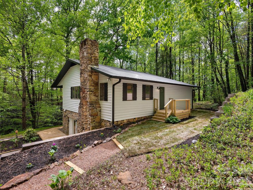 Fully renovated and move-in ready, this 3-bedroom, 3-bath home offers 2,822 square feet of updated living space on 2.49 +/- private acres in Hendersonville, NC. Surrounded by mature trees with a creek running alongside the property, this home delivers the privacy and natural setting you are searching for in Western North Carolina.
Recent upgrades include a new roof, new septic system, fresh exterior paint, and a complete interior renovation. The spacious layout provides flexibility, featuring a renovated lower basement level with a second kitchen—ideal for guests, multi-generational living, or potential rental use.
Located 20 minutes from downtown Hendersonville, this property offers a strong combination of modern updates, usable space, and a private mountain setting.