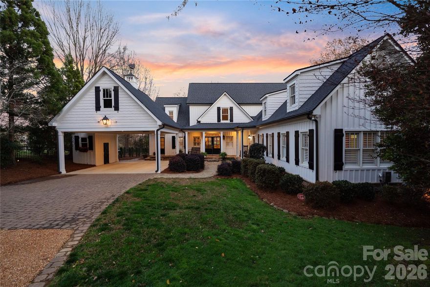 Privately positioned on Lake Norman, this charming farmhouse-style waterfront home offers a rare combination of warmth, privacy, and established lakefront living. Featuring 4 bedrooms, 4 full bathrooms, and 2 powder rooms, the residence is thoughtfully set on approximately one acre, creating a setting that feels both secluded and inviting.

A gated entrance and long winding drive introduce the property with a true sense of arrival, setting the tone for a home that balances peaceful retreat with convenient access to nearby dining, shopping, and everyday amenities.

Inside, hardwood floors and an open yet inviting floorplan create a comfortable balance between everyday living and effortless entertaining. Thoughtfully connected gathering spaces allow natural light to move throughout the home while maintaining a warm and welcoming atmosphere. The sunroom offers a beautiful place to begin each day, perfectly positioned for enjoying morning coffee while watching the sunrise over the water.

The primary suite is thoughtfully designed as a private escape, featuring access to an upper terrace and a spa-inspired bathroom complete with heated floors and a standalone soaking tub. A large custom walk-in closet enhances the suite, while additional storage areas - including space above the carport and another conveniently located off the primary closet .

Outdoor living is a defining feature of the property. A spacious back patio provides an ideal setting for hosting family and guests, complete with a fire pit for cool lake evenings and a built-in gas grill that supports easy outdoor dining and entertaining. Open lawn areas and established landscaping create a relaxed lake lifestyle environment, while a gentle transition leads toward the shoreline.

A private dock provides direct access to boating, paddle boarding, recreation, and sunset cruises, allowing everyday enjoyment of Lake Norman.

Despite its peaceful atmosphere, the home remains conveniently located near shopping, dining, and major access routes, creating a refined balance between privacy and connection. This is a compelling opportunity to secure an established waterfront property with timeless farmhouse appeal in one of Lake Norman’s most sought-after locations.