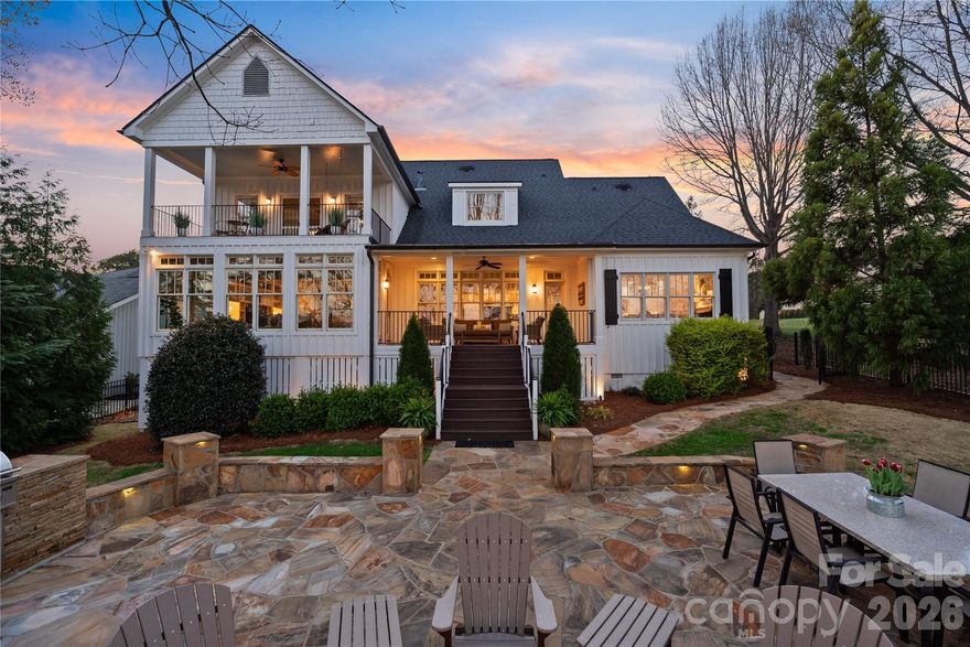 Privately positioned on Lake Norman, this charming farmhouse-style waterfront home offers a rare combination of warmth, privacy, and established lakefront living. Featuring 4 bedrooms, 4 full bathrooms, and 2 powder rooms, the residence is thoughtfully set on approximately one acre, creating a setting that feels both secluded and inviting.

A gated entrance and long winding drive introduce the property with a true sense of arrival, setting the tone for a home that balances peaceful retreat with convenient access to nearby dining, shopping, and everyday amenities.

Inside, hardwood floors and an open yet inviting floorplan create a comfortable balance between everyday living and effortless entertaining. Thoughtfully connected gathering spaces allow natural light to move throughout the home while maintaining a warm and welcoming atmosphere. The sunroom offers a beautiful place to begin each day, perfectly positioned for enjoying morning coffee while watching the sunrise over the water.

The primary suite is thoughtfully designed as a private escape, featuring access to an upper terrace and a spa-inspired bathroom complete with heated floors and a standalone soaking tub. A large custom walk-in closet enhances the suite, while additional storage areas - including space above the carport and another conveniently located off the primary closet .

Outdoor living is a defining feature of the property. A spacious back patio provides an ideal setting for hosting family and guests, complete with a fire pit for cool lake evenings and a built-in gas grill that supports easy outdoor dining and entertaining. Open lawn areas and established landscaping create a relaxed lake lifestyle environment, while a gentle transition leads toward the shoreline.

A private dock provides direct access to boating, paddle boarding, recreation, and sunset cruises, allowing everyday enjoyment of Lake Norman.

Despite its peaceful atmosphere, the home remains conveniently located near shopping, dining, and major access routes, creating a refined balance between privacy and connection. This is a compelling opportunity to secure an established waterfront property with timeless farmhouse appeal in one of Lake Norman’s most sought-after locations.