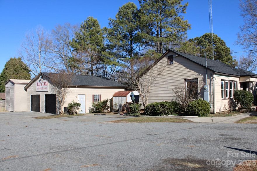 Previously utilized as a taxi service, this property boasts a number of improvements, lending itself perfectly to an automotive dealership, automotive service, or office/storage perfect for trades. Comprising a former residence converted into an open-floor office spanning approximately 700 square feet, a two-bay garage covering approximately 800 square feet, a single-bay truck/RV bay measuring approximately 275 square feet, and two supplementary metal storage buildings, each encompassing approximately 150 square feet. 

Situated at a prominent corner, the property is characterized by a fully paved lot featuring two points of ingress/egress. Positioned just one block off North Cannon Blvd (Hwy 29) and conveniently equipped with a traffic signal at Jackson Street, the location is highly desirable. 

This property has recently had a new roof installed on the garage and office, and a new HVAC system is being installed.
