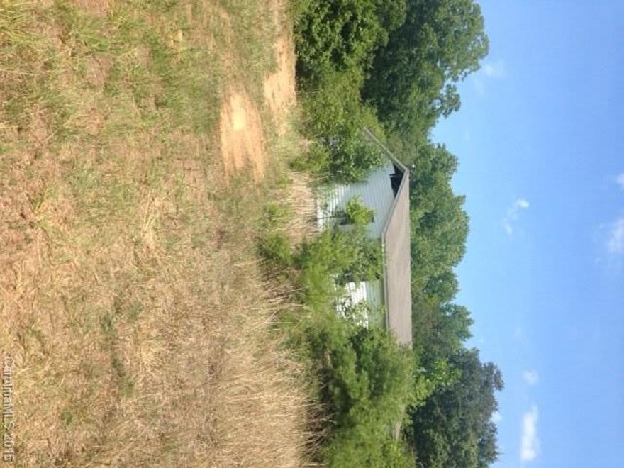 Manufactured home on 1.71 acres, has not been lived in or the land maintained for about 8 years. It is very grown up. The house is in fair condition on the inside. Could be a diamond in the rough if you are looking for privacy. The property is down a long rutted dirt road. The seller will not do any repairs, being sold "AS IS".  drive carefully when going on the road to the house.