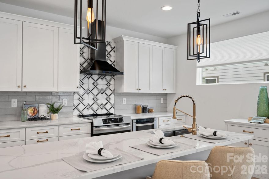 Set in the heart of Wesley Heights and just minutes from Uptown, this modern townhome delivers true city living with space to breathe. Walk to dining, breweries, the greenway, and trolley, then come home to your own private rooftop retreat with more than 800 square feet of outdoor living and skyline views. Inside, the open layout is bright and inviting, built for both everyday living and effortless entertaining. The kitchen anchors the main level with a generous island, stainless steel appliances, and added custom cabinetry and counter space that elevate both style and function. The primary suite feels like a retreat, complete with dual closets and a spa-style bath featuring an oversized shower and soaking tub. A lower-level bedroom with ensuite bath works perfectly for guests, a home office, or private flex space, while an additional bedroom and full bath offer even more versatility. A two-car garage prewired for an EV charger and ample storage add practicality to the design, making this home as functional as it is striking. Rooftop views, walkability, and modern design come together in one of Charlotte’s most dynamic neighborhoods.