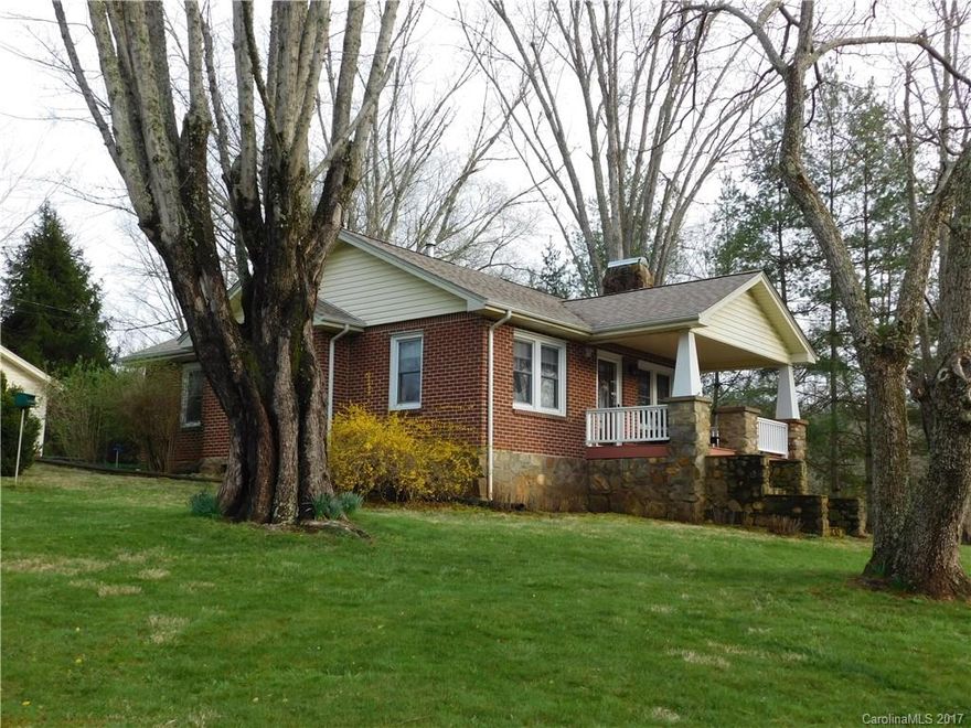Sweet Country living is what you will find in this great home!  Enjoy the view of the river and countryside from the front porch.  Features a spacious kitchen and formal dining room.  Hardwood floors throughout along with many updates .  Nicely landscaped with a detached single garage and workshop.  Nice big barn for more parking or many other uses... Relax in the hot tub among the mature trees in the sun room.  Convenient to I-40 and just minutes to downtown Asheville.