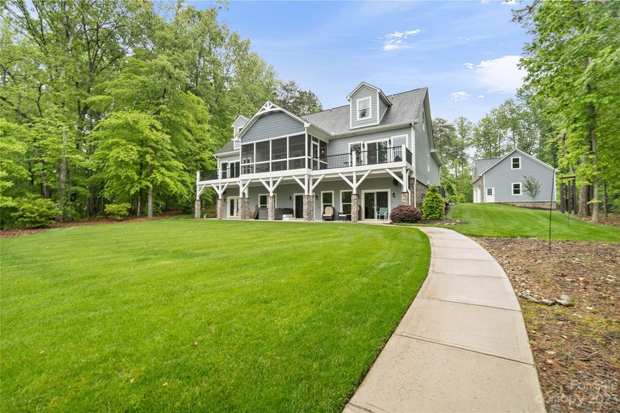 Located on an expansive 1.37-acre lot, this large home exemplifies lakeside living. Complete with total garage space for four cars, wired workshop with 220 volt. Main level welcomes you with an open floor plan and cottage-style stone fireplace and gas logs perfect for cool evenings. Enjoy the outdoors while relaxing on the screened porch. TWO primary suites on the main level, with access to decks overlooking the lake, walk-in closets, luxurious claw foot tub, and double vanities. Upstairs, two additional bedrooms with en-suite baths and a bonus room provide ample space for a teenager’s retreat. Lower level transforms this property into an entertainer’s haven, wet bar, rec room, lakeview office and full bath. Covered patio with hot tub invites you to unwind while enjoying the surroundings. Level yard facilitates easy trips from dock to the house. Dock has lift, water sports launch and sitting area. Minutes to the Main Channel, located on a quiet cove. Your lakeside retreat awaits.