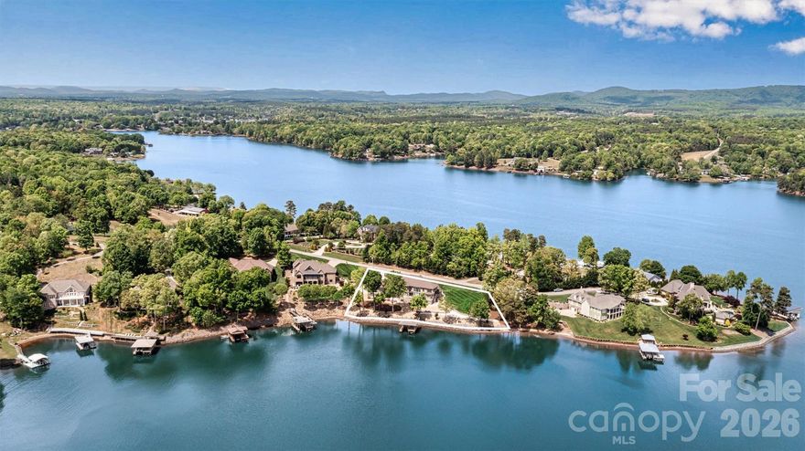 Luxurious Lake Hickory Living – Welcome to 4202 54th Ave NE – A serene lakeside sanctuary where tranquil lakefront living meets refined sophistication. This meticulously maintained executive residence, embodies the pinnacle of lakefront elegance. Perfectly positioned on lush 0.86-acre grounds with approximately 263 feet of pristine deep-water shoreline and coveted main channel views, this home is an entertainer’s dream. Set along a quiet, established cul-de-sac, it offers a peaceful retreat where residents stroll, bike, and savor the serenity of lakefront living.

A grand two-story foyer welcomes you, flowing seamlessly into the stunning two-story great room, where expansive windows frame sweeping lake views and radiate sunlight throughout the home. The gourmet kitchen is a chef’s sanctuary, featuring expansive granite counters, a 6-burner gas cooktop, dual ovens, and two walk-in pantries, ideal for preparing everything from casual family meals to lavish dinner parties. Delight in casual lakeside dining or host unforgettable gatherings in the dining room, perfectly designed for entertaining with effortless style.

The main level primary suite offers a private sanctuary, boasting soaring 20-foot ceilings and expansive windows that capture breathtaking lake views. The spa-inspired ensuite features dual vanities, a custom tile shower, and a jetted tub perfectly positioned to soak in the serene backdrop, while two walk-in closets complete this indulgent retreat.

A secondary main level bedroom with full bath and walk-in closet provides guests or multi-generational family members with comfort and privacy. The private office, adorned with bespoke built-ins and a trophy case behind elegant French doors, offers a refined space for work, study, or reflection. A powder room completes the main level, while a spacious laundry room with deep sink and direct lakeside access ensures effortless organization after a day on the water.

Upstairs, versatility meets leisure and luxury. A welcoming sitting area and recreation room with mini-bar create the perfect venue for family game nights, celebrations, or relaxed entertaining. A third bedroom shares a full bath with access to a flex room, offering ample space for guests, hobbies, or play. A second flex room with generous storage provides an ideal setting for crafting, fitness, or additional living needs.

Car enthusiasts and entertainers alike will delight in the four-car garage with professional epoxy flooring, thoughtfully designed to extend the home’s entertainment potential. Three sets of French doors open to the lakeside patio, seamlessly connecting indoor and outdoor spaces. A kitchenette with custom cabinetry, beverage refrigerator, and ice maker, complemented by a convenient half bath, elevates outdoor entertaining to effortless elegance.

Storage abounds with a walk-in crawlspace featuring a 6' garage entry, perfect for a golf cart or lake toys. Outdoors, the expansive shoreline provides sweeping main channel views, and a new stationary dock completes this lakeside paradise.

Location is unmatched being minutes from Catawba Springs Golf Course, 15 minutes to downtown Hickory, and 60 minutes to Charlotte Douglas Airport. Enjoy as a weekend retreat or full-time residence, this extraordinary home offers a rare opportunity to experience the ultimate in Lake Hickory living.