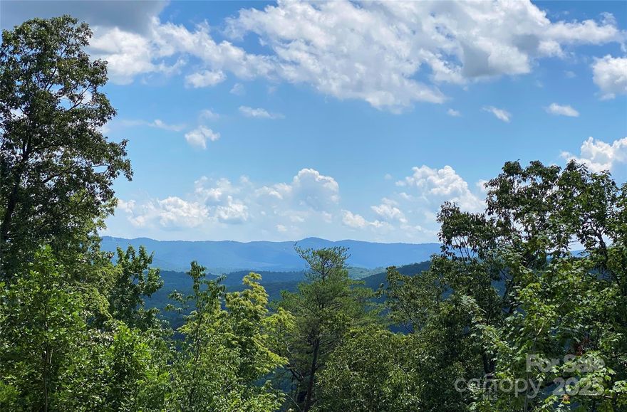Gorgeous panoramic view lot at Estates at The Boulders. The créme de la créme of homesites, only 11 lots are in this coveted section of The Boulders, all with fabulous views, privacy and stunning high end homes already built. With Estates 1 you'll get wide pristine panoramic south facing views, as well as views to the east and west. A stunning mountain modern home was designed for the lot and available with lot purchase. The Boulders is a gorgeous gated mountain conservation community in the most amazing/convenient location just 6 minutes to Main St Hendersonville, under 25 min. downtown Asheville. You'll find beautiful luxury homes built ranging from traditional to contemporary style.