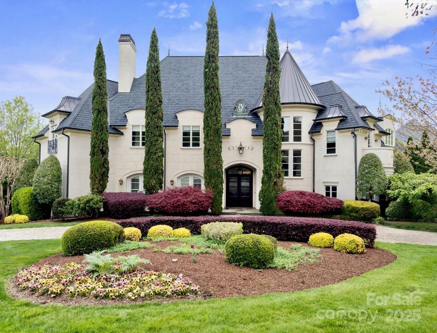 An extraordinary European-inspired estate in the heart of Ballantyne Country Club, this architectural gem blends timeless elegance with refined craftsmanship. An elegant spiral staircase and barrel dome ceiling set the tone for the open, light-filled layout. The great room features hand carved travertine mantel, the chef’s kitchen offers top-appliances, custom cabinetry, and wet bar.
Designed for luxury and flexibility, the home offers 2 spacious primary suites for multigenerational living or hosting guests in style.The outdoor area is all seasons entertainer’s dream: covered patio is newly upgraded  with built-in grill, outdoor IR heaters, fireplace, and heated resort-style pool. A 3-car garage adds everyday convenience. Ballantyne Country Club offers optional multiple tiers membership with access to golf, tennis, fitness, dining, and social calendar. Perfect blend of European charm and modern luxury, just minutes from Ballantyne’s top dining, shopping, and schools.
