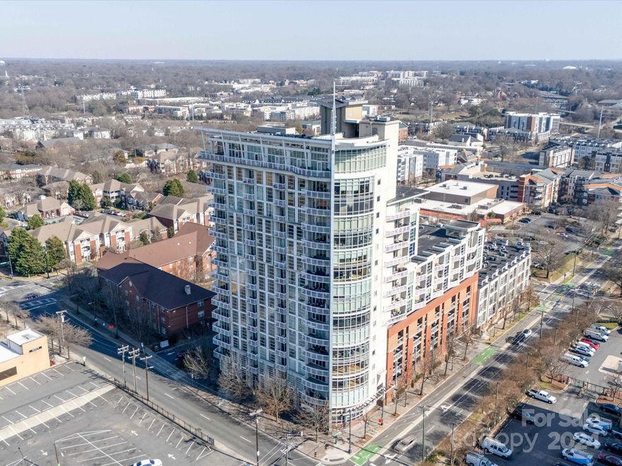 Welcome to this 8th floor unit with gorgeous skyline views in the heart of Center City! Floor-to-ceiling windows flood the space with natural light, creating an inviting atmosphere within the condo’s open floor plan. Bamboo floors & crown molding throughout main area, remodeled bathroom with custom huge tile shower, & also huge walk in closet with built ins.  This is one of the few units in the building with ceiling plastered & painted white vs the concrete look of the others! Take in panoramic views from the building’s rooftop terrace, exploring what Uptown Charlotte has to offer. Courtside is a secure building with controlled access and dedicated parking, to ensure peace of mind. Only 2 blocks from the light rail and situated along the bike path connecting the greenway systems. Embrace city living without sacrificing comfort and style— Don't miss the opportunity to make this stunning condo your own!