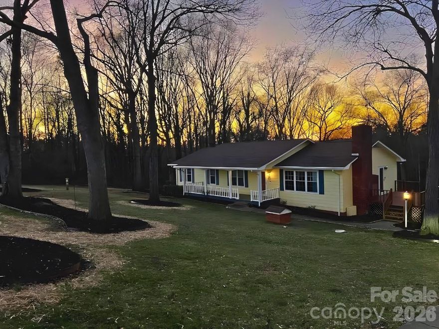 Move in ready beautifully maintained 3-bedroom, 3-bath home with partially finished basement, multiple entertaining areas, and peaceful natural surroundings.

This inviting home features a true rocking chair front porch — the perfect place to enjoy morning coffee or evening sunsets. Inside, the main level offers a spacious living room with a masonry gas log fireplace and woodbox, A large pass-through bar window connects the kitchen to the living area, making it ideal for entertaining.

The kitchen includes abundant cabinetry, under-cabinet lighting, and excellent functionality. You’ll also find a separate dining room and a laundry room with extensive cabinet storage.
A long hallway leads to three bedrooms and a full hall bath. The primary suite features a large en suite bathroom, providing privacy and comfort.

Downstairs, approximately 992 square feet of heated finished basement space offers incredible flexibility. There are trusses in the ceiling so you won't find the typical basement poles. The open area includes a second gas log fireplace, plus a bonus room (10'8" x 13') previously used as a bedroom. The basement bath includes a shower. There is also a one-car garage with additional workshop space.

Outdoor living is exceptional here:

Large side deck perfect for outdoor dining
Expansive lower-level deck ideal for entertaining
River rock firepit area
Two small playhouse-style outbuildings
Natural wooded setting with birds, deer, and squirrels

Additional features include:

Ceiling speakers in most rooms
50-gallon water heater
Owned gas tank (gas was supplied by Phillips & Lawing)
Full-house water filtration system
Quarterly pest service with Hutchins Pest Control

Conveniently located near Ellenboro, Forest City, and Mooresboro, this home offers peaceful country living with easy access to shopping, dining, and schools.

If you're searching for a home with a finished basement, outdoor entertaining space, and natural surroundings in Rutherford County, this is one you won’t want to miss.