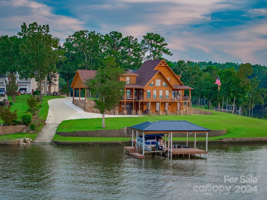 Experience the ultimate in Lake Wateree living with this stunning property featuring 4 bedrooms, 4 full baths, and 2 half baths, boasting over 350 feet of water frontage and breathtaking wide water views. The home showcases custom woodwork throughout. The main floor includes a gourmet kitchen, dining area, and a luxurious primary suite with a master bath, and custom walk-in closet. Upstairs, discover two additional spacious bedrooms, one with a loft perfect for a den or study. Fully heated/cooled basement, currently a workshop, includes finished bathroom and offers endless potential. Generac generator. Double garage hosts a beautiful one-bedroom apartment with its own kitchen, ideal for guest quarters or rental. The tiered yard leads to a covered dock with a boat lift and jet-ski ports, plus a private boat ramp and RV pad with a 50-amp hookup w/sewer and designated parking area. Covered parking and garage. This property is a dream come true for lake lovers. Schedule a showing today!