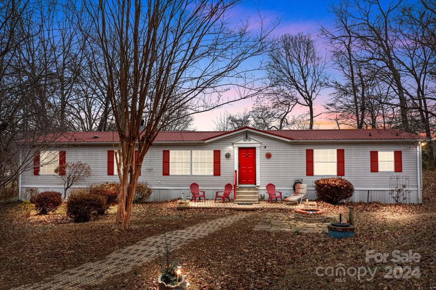 $5,000 Seller Credit with acceptable offer! Experience the tranquility of rural living, all while being just a 15-minute drive from downtown Statesville or Troutman, where you can indulge in shopping, dining, and more. This home, situated on nearly 3/4 acre without any HOA, provides privacy as it sits back from the road. Cozy up to the wood-burning fireplace in the den, or savor your morning coffee in the sunny breakfast area with scenic views of the pasture at the rear of the home. The HVAC system is only a year old, and the metal roof is approximately 10 years old. Appliances such as the refrigerator, washer, and dryer are included. Additionally, it's a short 5.5-mile drive to Lake Norman State Park, offering hiking and biking trails, boat rentals, and other recreational activities.