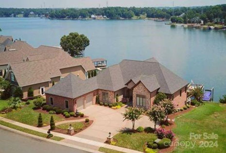 Impeccable lake home! Custom details! 5 bd & 4.5 bath. Primary/main. 2nd primary/lower. Chef's kitchen & hearth room. Wine cellar. Home theater-120 curved screen. Billiard & Poker rooms. Outdoors-2 covered patios, bar, outdoor warming drawer, built-in grill/cook top, hot tub, waterfall, tiered terrace, fire pit + 6 fire bowls, & Sonos Sound inside & outside. Two-level composite dock w/ TWO BOAT LIFTS, floating dock w/2 jet ski ports. 2-car garage w/ custom cabinets, epoxy flooring, VERSA Lift.