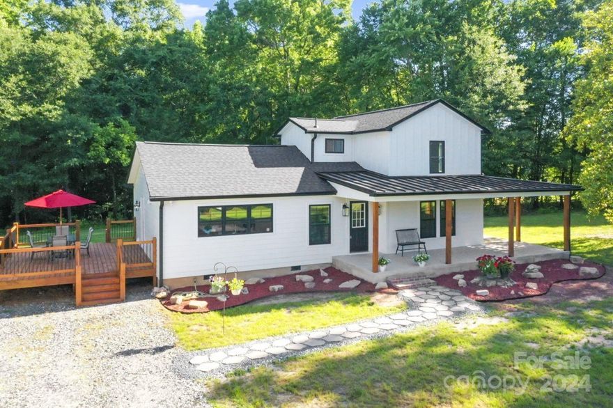 Beautiful and peaceful homestead with trees wrapping around offering privacy. The porch, so pleasant, wraps around, too! There seems always to be a breeze. The home is full of light airiness. All new in the last 6 months: electrical, plumbing, HVAC, sub-floors, floor coverings, drywall, paint, kitchen, baths, roof & more. The kitchen features luxury cabinets with upgrades including a drawer microwave and Samsung Bespoke white glass appliances plus gorgeous quartz countertops. The large island has extra storage and can seat up to five. There's even a cute little pantry for your overflow. Convenient access to the huge, new deck and the laundry room from the kitchen. A fireplace wall separates the kitchen and dining area and offers retreat space. And that guest bath! Must see. The owner's suite has a large walk-in closet, large shower and double vanity. Five minutes from Rte 73 dining and shopping in Denver, 10 min. to Lake Norman, 12 to Mt. Island Lake, 20 to Charlotte Douglas airport.