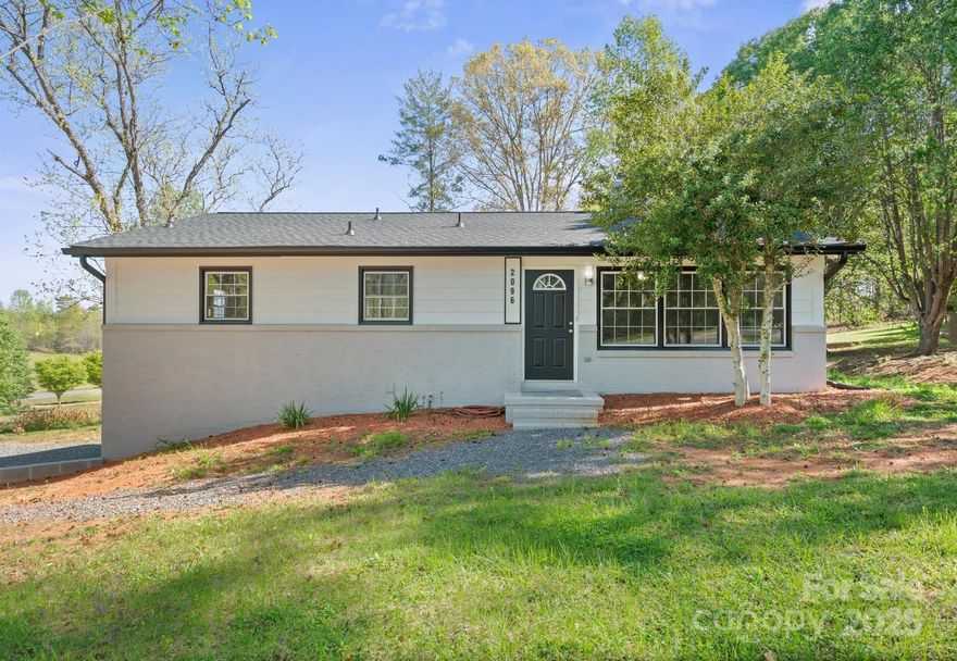 All brick renovated 4 BR / 2 Full BA home on 0.7-acres convenient to downtown Morganton shopping, UNC Health Hospital, I-40, Catawba River and Lake James amenities but with No City taxes. New roof 2022 & Heat pump 2023. Main level with a beautifully open floorplan with tons of natural light through new replacement windows. Living room w/ woodburning FP, 4 spacious bedrooms & full bathroom w/Dbl vanity & jacuzzi shower/tub. Lower living area with a gorgeous kitchen w/ ample counter space, lots of cabinet storage & new SS appliances.  Open dining area with a coffee/wine bar & wine refrigerator.  Spacious family room with 2nd fireplace w/woodburning cast iron insert. 5th/BR/bonus, 2nd Full bath w/walk in shower, Laundry & separate utility room. Step outside to your large patio perfect for summer gatherings. Landscaping w/mature trees and plenty of space for gardening or outdoor activities. Prettier in person and easy to show by Appt.