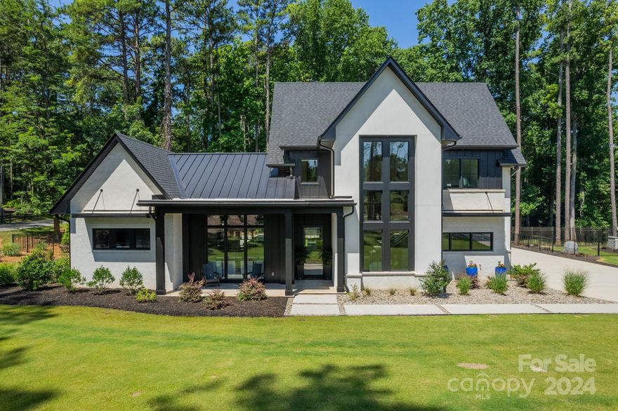 Welcome to your dream home! This modern sanctuary where luxury meets tranquility.This exquisite residence boasts a striking white stucco & brick facade complemented by the sleek black windows. Step outside to your private retreat: a massive outdoor patio perfect for year round entertaining.  The automated pergola provides versatile coverage for all seasons. Inside the home exudes sophistication w/ luxury vinyl plank & tile flooring throughout. The primary bedroom is a tranquil escape featuring a stunning wood accent wall & tall vaulted ceilings. The master bath features wood grain floating cabinets & textured wall over the vanity. The kitchen is a chef's dream w/ a spacious island, quartz countertops, 48" fridge & freezer, 6 burner gas cooktop & double ovens. The upper level features 3 spacious bedrooms, each w/ en suite bath. 1 bedroom boasts a private upper patio w/ glass panels. Versatile loft & a bonus room w/ a wet bar, modern wall tile and floating shelves.