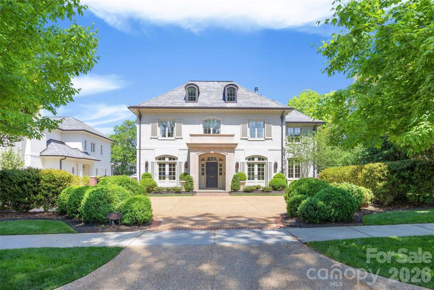 LUXURY LIVING IN MYERS PARK!  This custom residence, designed by Don Duffy and built by Gerrard Builders, is a seamless blend of sophistication and modern luxury.  Sun-filled interiors and soaring ceilings create an airy, refined backdrop, while a thoughtfully designed floorplan offers effortless flow for both entertaining and everyday living.  At the heart of the home, a showpiece chef’s kitchen features an oversized island, walk-in pantry, and opens seamlessly to the breakfast area, bar, and fireside family room.  The main level also offers a private guest suite with full bath, an inviting living room, formal dining room, and powder room.  Upstairs, the expansive primary suite is a true retreat, complete with a spa-like bath with soaking tub, oversized shower, and generous walk-in closet.  Three additional bedrooms, two full baths, a dedicated office, and laundry complete the second level.  The third floor offers a versatile sixth bedroom or bonus space with a full bath.  Outdoor living is equally impressive, with a covered porch featuring heaters and a fireplace overlooking a beautifully designed pool with an electric cover.  A terraced yard with a ramp for easy access and raised garden beds adds both function and charm, all surrounded by lush landscaping.  Additional highlights include a two-car garage, fenced backyard, abundant walk-out attic storage, and a prime location just minutes from the shops and restaurants of Myers Park, with easy access to Uptown.
