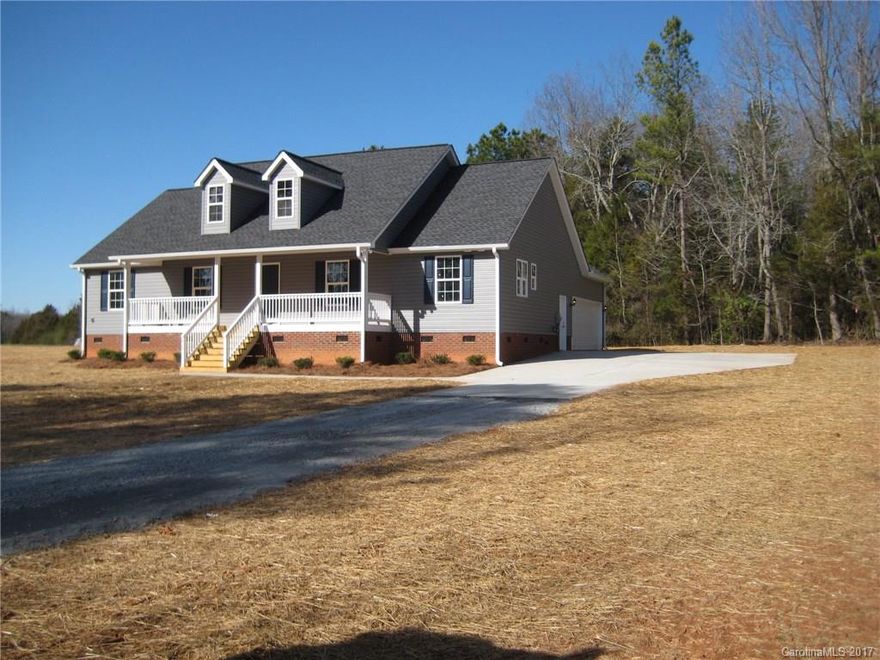 Country Living, open floor plan and split bedroom plan, kitchen w/ granite, island, black appliances, laminate flooring in kitchen, breakfast area, family rm (9 ft ceiling), and hallways, Large laundry room, gravel driveway leads to concrete entrance to double concrete pad entering garage, concrete sidewalk, covered back porch, 1 Acre lot.