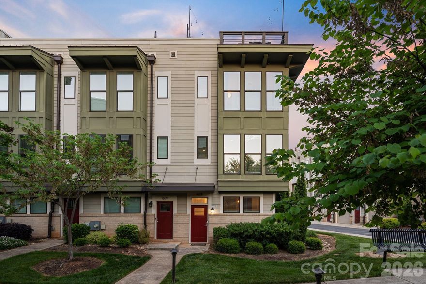 Located in the heart of Wesley Heights, this fully upgraded townhome offers refined urban living just minutes from Uptown Charlotte. Set within a beautifully maintained community with lush landscaping and inviting green spaces, the residence blends modern design, elevated finishes, and exceptional outdoor living all with effortless access to major roadways and city conveniences.

The interior is filled with abundant natural light, highlighted by a desirable corner position and expansive west-facing windows. The main level is designed for both everyday living and entertaining, featuring a spacious living area that flows seamlessly into a beautifully upgraded kitchen. Quartz countertops with waterfall edge detailing, a full-height stone backsplash, and updated West Elm lighting create a sophisticated aesthetic, while high-end appliances deliver both form and function. A custom bar with integrated wine display adds a distinctive touch, ideal for hosting. Just off the kitchen, a covered patio offers a comfortable outdoor retreat with views of Uptown.

Upstairs, the primary suite is a serene escape, complete with designer finishes, dual closets, and a spa-inspired bath featuring a walk-in glass shower and dual vanities. A secondary bedroom functions perfectly as a guest space or office, enhanced with custom built-ins and direct access to the home’s standout feature, an extraordinary rooftop terrace. Outfitted with upgraded wood flooring, turf accents, and ambient string lighting, this elevated outdoor lounge captures breathtaking, unobstructed views of the Charlotte skyline, creating a true extension of the living space.

The lower level adds versatility with a spacious bonus room, ideal for guests, a home office, or additional living space, along with direct access to a well-appointed garage featuring durable rubber flooring and ample storage. Throughout the home, thoughtful upgrades, including smart lighting, custom millwork, designer wallpaper, and a built-in security system, enhance both comfort and style. This stunning residence presents a rare opportunity to own a meticulously curated home in one of Charlotte’s most dynamic and connected neighborhoods.