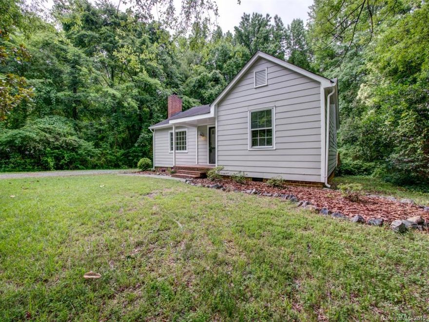 Quaint ranch complete with updated kitchen and bath, bamboo floors throughout, fresh paint inside and out.  It is just waiting for the owner to move in.  Spacious great room with a wood burning fireplace is just the place to relax and unwind.  The updated kitchen offers ss appliances, island, updated fixtures and wooden beam  that opens to the large breakfast area.   Unwind at the end of the day on the deck overlooking wooded back yard.