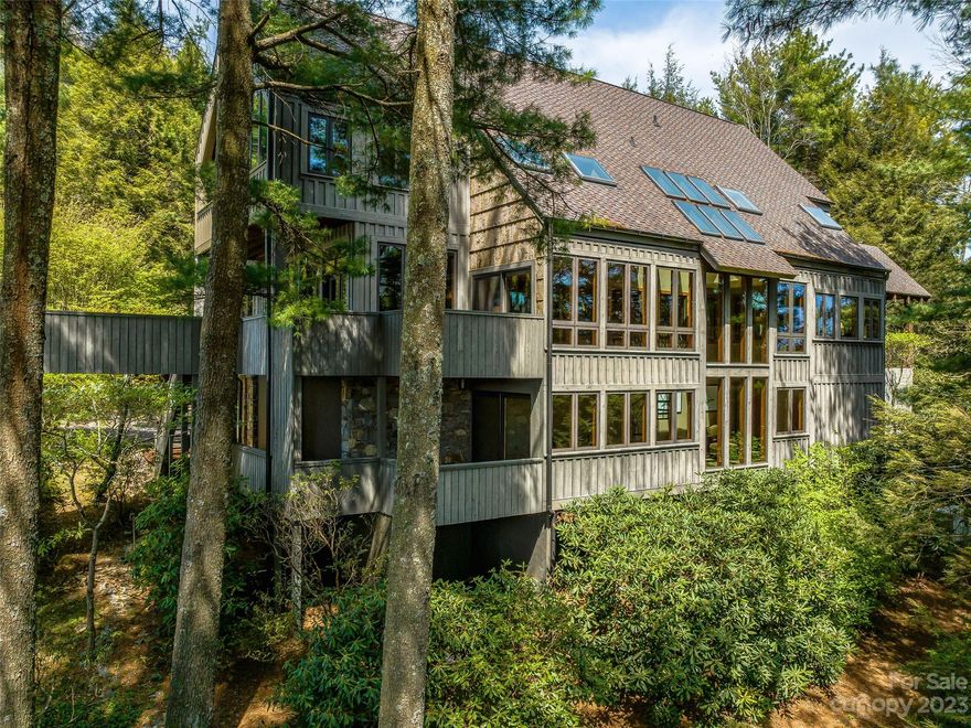 Architecturally stunning, Grove Park-inspired, unique mountain modern luxury home on Town Mountain in beautiful Mountain Meadows. Come home to three primary suites, 3/2 baths, open living with a soaring stone fireplace, vaulted exposed beam ceilings, chef's kitchen w/Dacor appliances, day/breakfast room, loft office, solarium, 4-car garage, multiple decks and mountain views from every window. Thoughtfully rebuilt interior and exterior including electrical, plumbing, windows, millwork, baths, siding and roof, all with the finest finishes and touches. Mountain-top living at its finest in a home designed for entertaining and hosting where character and ease of living are abundant and every season brings blooms. The many impressive outdoor spaces create a natural in/out flow to enjoy the treehouse feel amongst the pines and distant views. Minutes from downtown, Blue Ridge Parkway, hiking trails and all that Asheville has to offer in shopping, dining, arts and entertainment. Welcome home!