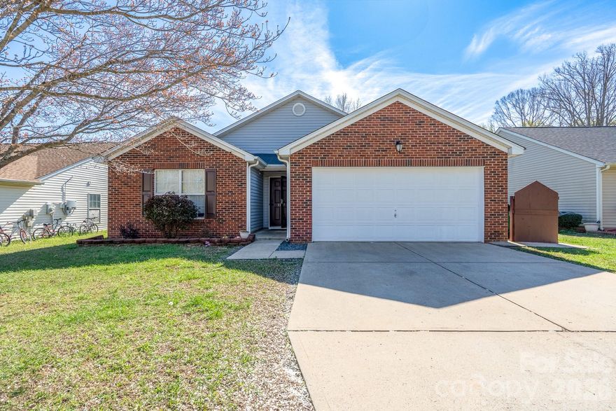 Welcome to this charming 3-bedroom, 2-bath home offering comfortable single-level living, convenient to UNCC, I-85 & I-485. This well-maintained property combines spacious design, and accessibility—perfect for homeowners and investors alike. Step inside to a bright open living area featuring vaulted ceilings and a cozy fireplace, creating a warm and inviting atmosphere ideal for relaxing or entertaining. The primary suite also features vaulted ceilings, giving the room an open, airy feel and a relaxing retreat at the end of the day. Each bedroom includes its own walk-in closet, providing generous storage throughout the home. Outside, enjoy a spacious backyard and patio area—perfect for weekend grilling, entertaining friends, or creating your own outdoor oasis. The attached two-car garage provides plenty of space for parking, storage, or a home workshop. No HOA, giving you the freedom and flexibility many buyers are looking for
