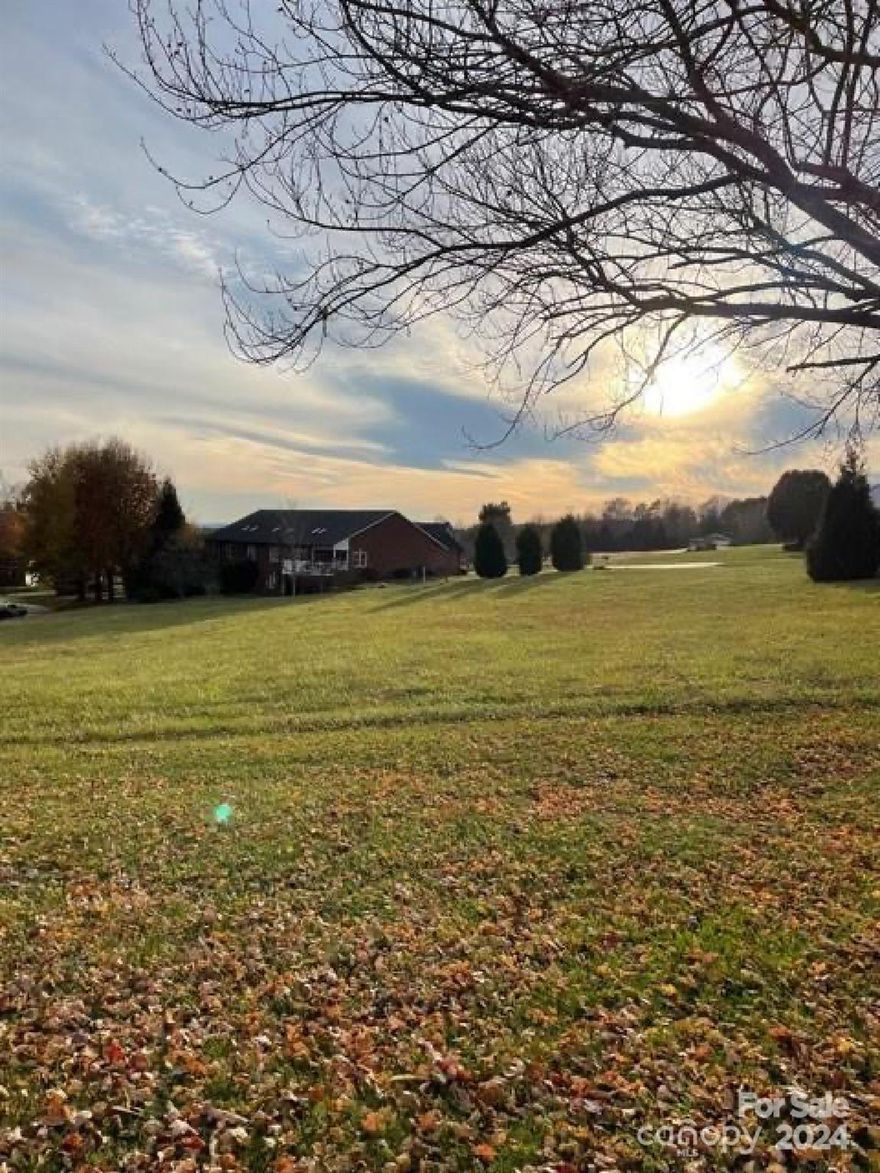Great mostly level lot in Burke county's finest golf course community w/ a 170-acre Tom Jackson-designed course, & South Mountain views. Even more this community boasts walking trails, a fishing pond, cart trails, tennis courts, and a pool. Enjoy the beautiful clubhouse that offers a restaurant, pro shop, locker room, meeting/party rooms, and social events. This gated community is situated less than 15 mins from Lake James & Morganton, 45 mins to Asheville, and less than 5 min access to the interstate. Our beautiful area is a mecca for outdoor lovers offering nearby access to one of the US TOP 10 cleanest lakes, multiple state parks, hiking/biking, breweries, wineries, restaurants, & so much more! This lot will accommodate almost any style of home. Public water & underground utilities are available. 1800 heated sqft is the required building minimum for this lot.