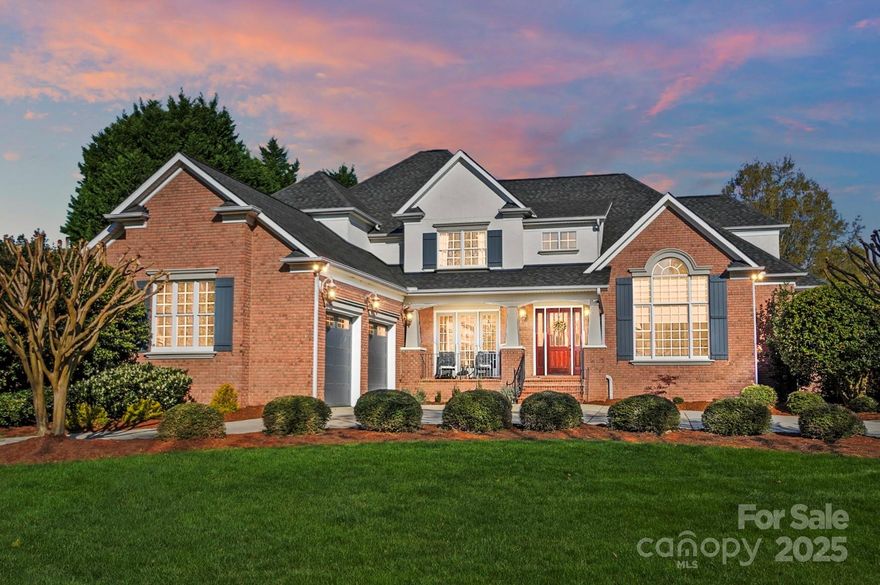 This stunning home is nestled within an exclusive gated community. The welcoming circular driveway and charming porch set the tone for what lies beyond. Step inside to a grand two-story entry hall, where elegance meets warmth with a curved staircase. The great room featurs a stone fireplace, built-ins, and sunlit spaces. The chef's kitchen is complete w/ breakfast area and vaulted ceilings, alongside a space ideal for a scullery or home management area. Also on the main is the primary retreat with soaring ceilings, offering a sitting area and access to the back porch. Upstairs, three additional bedrooms and a loft provide flexibility for an office or playroom. The expansive walk-out basement is an entertainer's paradise with a bar area, family room, and guest suite. Outside, unwind by the wood-burning fireplace, perfect for soaking in nature's beauty. Neighborhood walking trails, pickleball/tennis courts, inground pool, clubhouse, fitness center, playground, and ponds. Marvin Schools.