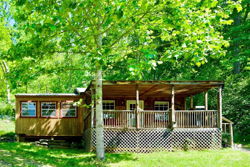Back on the market with a $2,700 price improvement—come on back and take another look!If you’ve been dreaming of a Western North Carolina mountain cabin, this one’s got that cozy feel without the big upkeep. This fully furnished tiny home in the Blue Ridge Mountains sits in a peaceful setting with beautiful mountain views and easy access to some of the best outdoor spots around.—Inside, you’ll find a smart 420 sq ft layout with an open kitchen and living area, plus a spacious bedroom that don’t feel cramped. It’s set up and ready to go—just bring your clothes and groceries. With propane and electric heat, you can stay comfortable here year-round.—Step out on the covered front porch, pour yourself a cup of coffee, and take in those quiet mountain mornings. It’s the kind of place folks come to slow down, unplug, and enjoy the simple life. You’ve also got a 24x36 detached building with all kinds of potential—turn it into a guest house, workshop, garage, studio, or even another rental space.—Location-wise, it’s hard to beat—just minutes to the Toe River, the Appalachian Trail, and Roan Mountain State Park. Whether you’re into fishing, hiking, kayaking or skiing in the North Carolina mountains, you’re right in the middle of it all.
?? No restrictions? or HOA rules/fees. ?? Short-term rental friendly (Airbnb/VRBO potential)?. ?? Tiny home investment opportunity. ??? Utilities in place: electric, water, septic, cable.  ?? Room for an RV or camper setup.  This would make a great mountain getaway, vacation rental or full-time home if you’re looking to simplify and still have a little land to breathe.—If you’ve been wanting a place in the Blue Ridge Mountains near Burnsville, NC with privacy, flexibility, and income potential, this one’s worth a look.