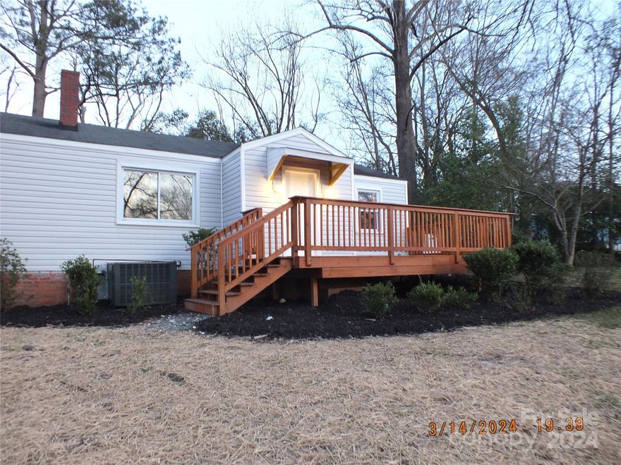 Back on the market due to no fault of the seller, this updated home in Lancaster, close to town, hospital, and access to Hwy 521, this 3 bed 2 bath home offers new baths with walk in showers in both, large primary bedroom, appliances to convey including washer and dryer, new hot water heater New flooring all the way through and freshly painted. Wood burning fireplace in den, with  dining room and kitchen combined. Outside offers large deck on front, circle drive, storage building with power all on a corner lot.