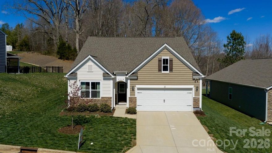 Discover the perfect blend of modern comfort and timeless charm in this move-in-ready, single-level 3 bedroom, 2 bath, 1,651 sq. ft home w/mature trees and an established lawn versus sod.  While not age-restricted, the easy, all-on-one-level layout makes this home a standout choice for anyone seeking comfort, convenience, and low-maintenance living in a USDA eligible community. Seller offering buy down rate through NextHome Mortgage.
Step outside to a beautifully landscaped, low-maintenance yard with river rock accents and a covered back porch—ideal for morning coffee, bird watching, or winding down in the evening. The wooded backdrop adds a sense of privacy and a peaceful, natural view.  The open-concept kitchen, dining, and living area—with soaring 9-foot ceilings and a cozy gas log fireplace with blower—creates one spacious, connected great room that’s perfect for everyday living and entertaining.  Thoughtfully designed and gently lived in, this one-owner home is loaded with upgrades such as a Deako Smart Switch Lighting Automation Package & premium fixtures beyond the builder's standard lighting offering. Better yet, the washer, dryer, and refrigerator are included. 
Enjoy the charm of small-town living with modern amenities in a community that feels like stepping back in time, with its nostalgic firehouse & elementary school. Enjoy extra wide streets only found in Phase One of the neighborhood.    Every detail is in place so you can move right in and start enjoying life!  Outdoor lovers will appreciate being just minutes from Lyle Creek Greenway and Riverbend Park for walking, biking, and soaking up nature.Ideal location! In addition to being close to downtown Conover, the home is conveniently located to the ever growing cities of Hickory and Denver.