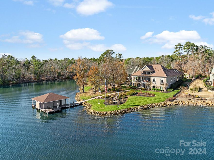 Long Range Views from this Custom Built Lakefront home offering the highest level of craftsmanship. Newly Renovated Gourmet kitchen with top-of-the-line appliances, custom cabinetry and spacious island. Floor to ceiling windows throughout the home brings in magnificent views of Lake Tillery. This home offers 5 bedrooms, each with its own full bath and walk-in closet. The entire third floor is a private oasis, the primary suite with lakefront balcony, oversized walk in closets and finished attic space for additional closet/storage which includes the 2nd laundry, home office with built ins and additional flex space. Custom features expands to walkout basement. Movie theater, 2nd kitchen, living room along with the 5th bedroom w/private bath makes for the perfect In-Law Suite. All levels of this home accessible by elevator. 3 car basement garage w/additional storage. Stroll down to your private boat dock, plenty of room for your lake toys with 2 slips, w/ boat lifts & jet ski floater.