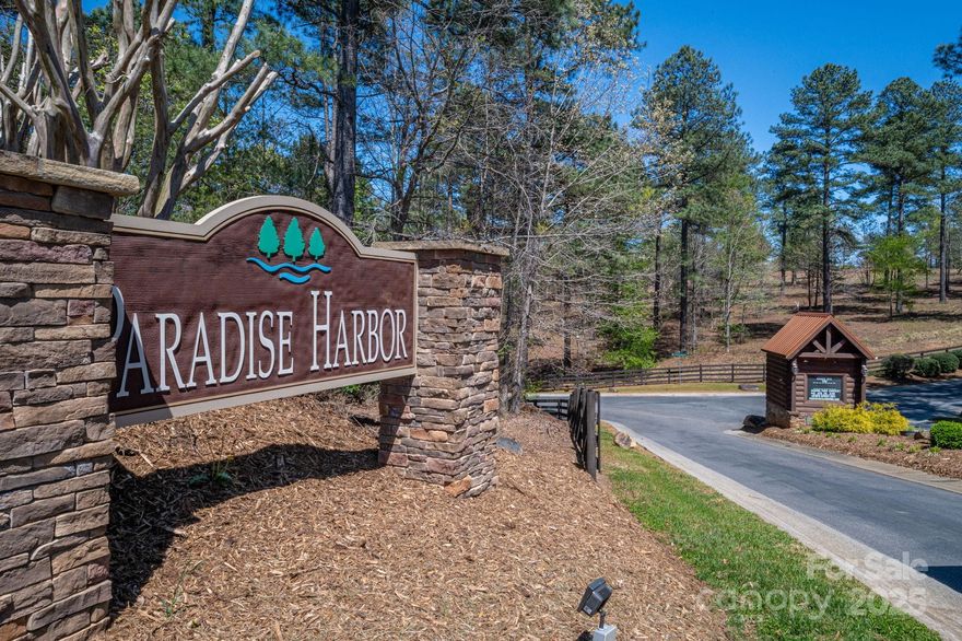 Live the Lake Life in Paradise Harbor! Discover your perfect lakefront escape in the prestigious gated community of Paradise Harbor, nestled along the scenic shores of Lake Rhodhiss in North Carolina’s Blue Ridge Mountains. This gently sloping waterfront lot offers stunning views and a prime location to build your dream home. Community amenities include paved roads, underground utilities, high-speed internet, and a lakeside common area with a community boat slip and paddlesport launch site. There is strong potential for a private dock (pending approval) from Burke County and Duke Energy. Site has been reviewed by Charlie Washburn of Marine Construction, who believes dock installation is likely feasible. Conveniently located near the I-40 corridor, you're just a short drive to Charlotte, Asheville, and Hickory, offering the perfect blend of mountain serenity and city accessibility. Enjoy boating, fishing, and lakeside living—your waterfront lifestyle starts here!