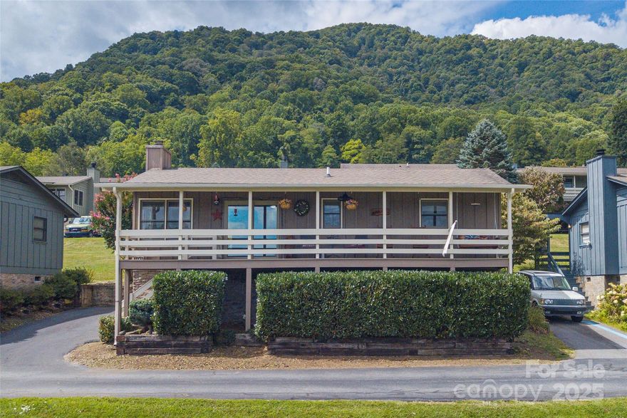 Cozy Mountain View Retreat! Enjoy breathtaking year-round sunrises and sweeping mountain views from the expansive covered front porch of this Maggie Valley home. Featuring an open floor plan with 2 bedrooms and 2 baths, this home is designed for both comfort and nice outdoor space. The stone fireplace with gas logs creates a warm ambiance.  Nice wide Pella sliding glass doors to the front and back covered porches.
The partially finished crawl space offers excellent potential for a workshop or additional storage. Nestled in a pet-friendly neighborhood, this home is ideally located near Maggie Valley, Waynesville, and the Cherokee Reservation.
Some of the upgrades include Corian kitchen countertops, artisan vanities, a walk-in tile shower, and beautiful flooring throughout.
Schedule your showing today and experience mountain living at its finest!
